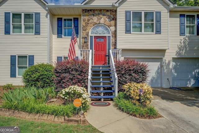 3870 Michaels Creek Ct, Loganville, GA 30052 - view of front of house featuring a garage, asphalt driveway, and stone siding