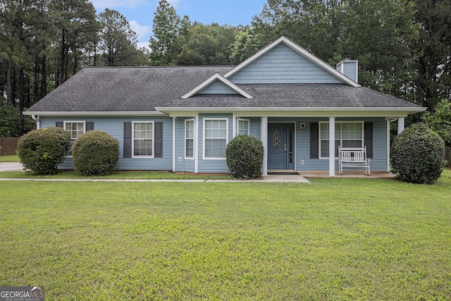 643 Lora Smith Rd, Newnan, GA 30265 - view of front of home featuring a chimney, roof with shingles, a front lawn, and covered porch
