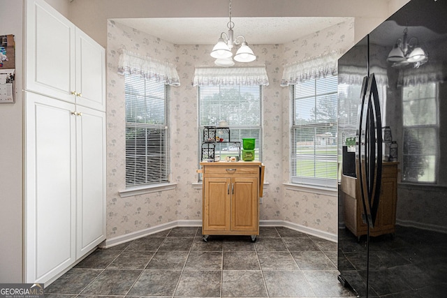 643 Lora Smith Rd, Newnan, GA 30265 - dining room featuring wallpapered walls, baseboards, and a chandelier