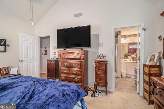 643 Lora Smith Rd, Newnan, GA 30265 - bedroom with light carpet, high vaulted ceiling, connected bathroom, and baseboards