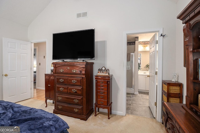 643 Lora Smith Rd, Newnan, GA 30265 - bedroom with light carpet, high vaulted ceiling, baseboards, and ensuite bath