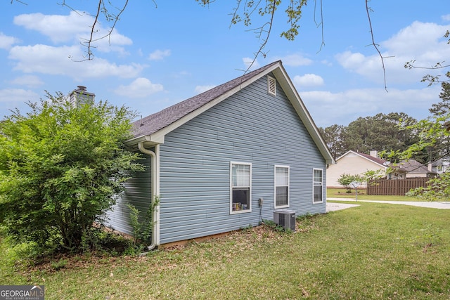 643 Lora Smith Rd, Newnan, GA 30265 - view of home's exterior featuring a chimney, central AC unit, and a shingled roof