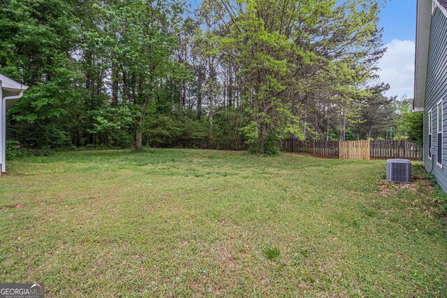 643 Lora Smith Rd, Newnan, GA 30265 - view of side of home with a chimney, central air condition unit, and roof with shingles