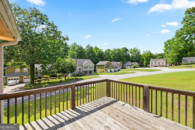wooden terrace featuring a residential view and a yard