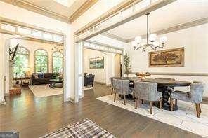 415 Morgan Falls Chase, Canton, GA 30114 - dining room with ornamental molding, a chandelier, and wood finished floors