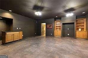415 Morgan Falls Chase, Canton, GA 30114 - unfurnished living room with concrete flooring