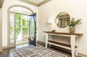 415 Morgan Falls Chase, Canton, GA 30114 - doorway to outside featuring crown molding and baseboards