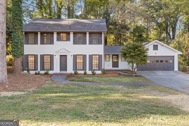4045 White Oak Ln SW, Lilburn, GA 30047 - colonial inspired home featuring a garage, driveway, a front lawn, and roof with shingles