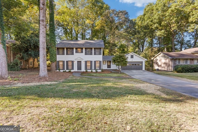4045 White Oak Ln SW, Lilburn, GA 30047 - colonial home featuring driveway, a front lawn, and a garage