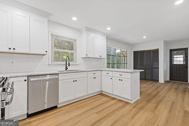 4045 White Oak Ln SW, Lilburn, GA 30047 - kitchen with appliances with stainless steel finishes, a sink, backsplash, light wood-style floors, and recessed lighting
