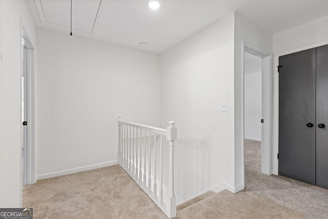 4045 White Oak Ln SW, Lilburn, GA 30047 - corridor featuring attic access, carpet floors, an upstairs landing, and baseboards