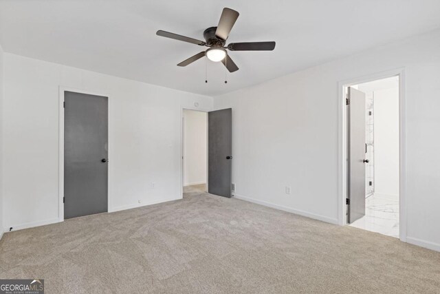 4045 White Oak Ln SW, Lilburn, GA 30047 - unfurnished bedroom featuring carpet floors, baseboards, and ensuite bathroom