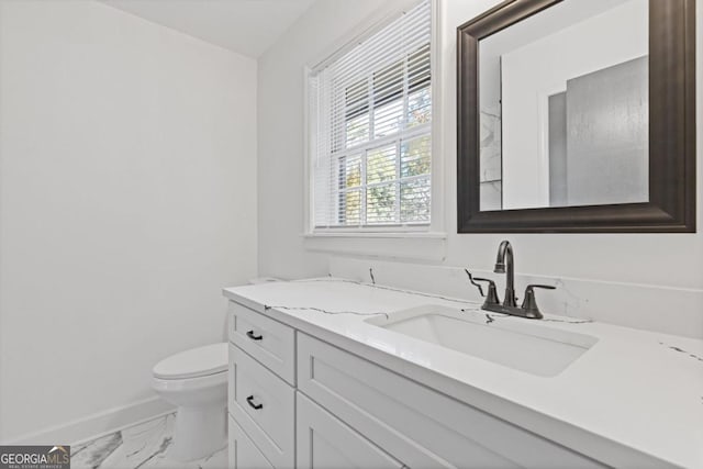 4045 White Oak Ln SW, Lilburn, GA 30047 - bathroom featuring marble look tile flooring, baseboards, toilet, and vanity