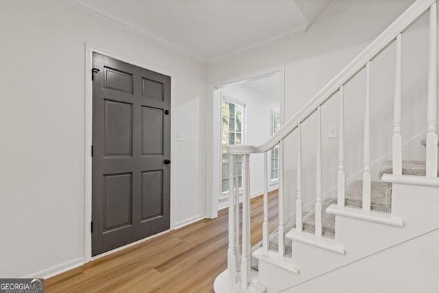 4045 White Oak Ln SW, Lilburn, GA 30047 - entryway with stairs, light wood-style floors, crown molding, and baseboards