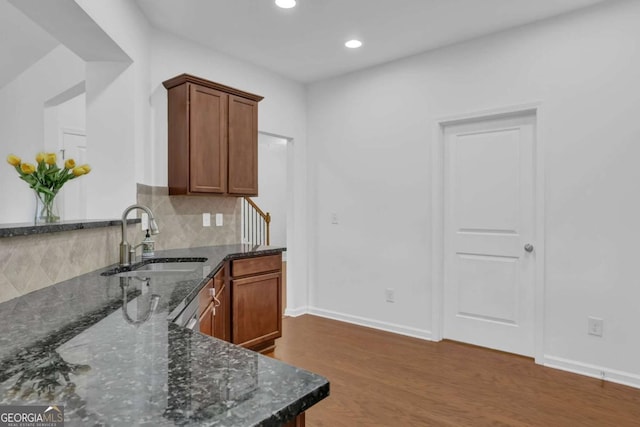 1929 Brightleaf Way, Marietta, GA 30060 - kitchen featuring dark wood-style flooring, dark stone counters, decorative backsplash, recessed lighting, and brown cabinets