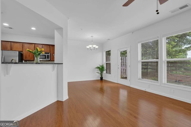 1929 Brightleaf Way, Marietta, GA 30060 - unfurnished living room with ceiling fan, wood finished floors, a chandelier, and recessed lighting
