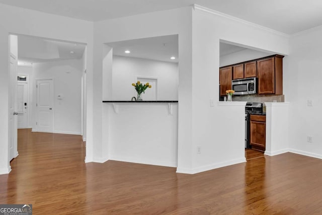 1929 Brightleaf Way, Marietta, GA 30060 - kitchen featuring stainless steel microwave, range with gas cooktop, wood finished floors, backsplash, and recessed lighting