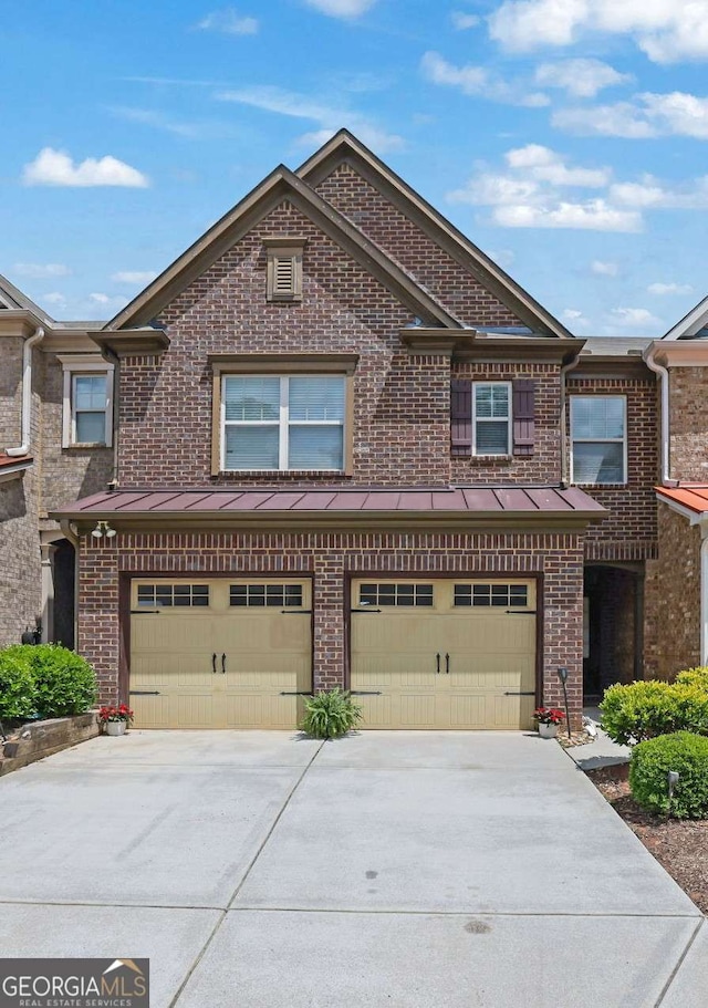 1929 Brightleaf Way, Marietta, GA 30060 - townhome / multi-family property featuring brick siding, a garage, driveway, and a standing seam roof