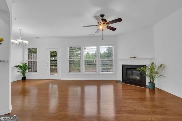1929 Brightleaf Way, Marietta, GA 30060 - unfurnished living room with wood finished floors, a fireplace with flush hearth, a ceiling fan, and a chandelier