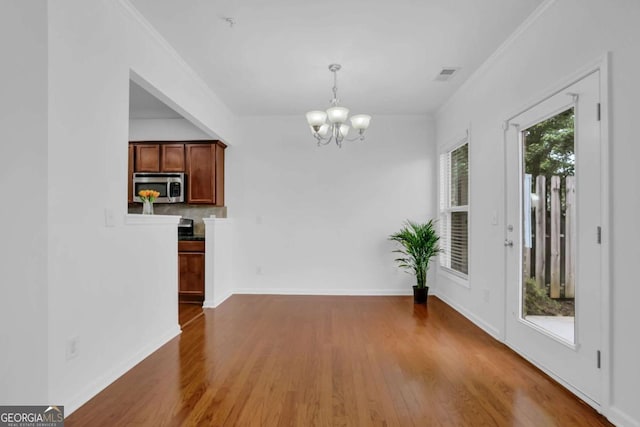 1929 Brightleaf Way, Marietta, GA 30060 - unfurnished dining area featuring a chandelier, wood finished floors, and ornamental molding