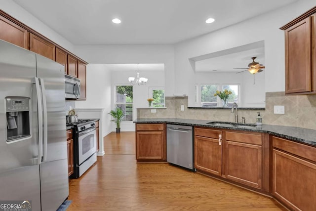 1929 Brightleaf Way, Marietta, GA 30060 - kitchen featuring stainless steel appliances, light wood-style floors, backsplash, dark stone counters, and recessed lighting