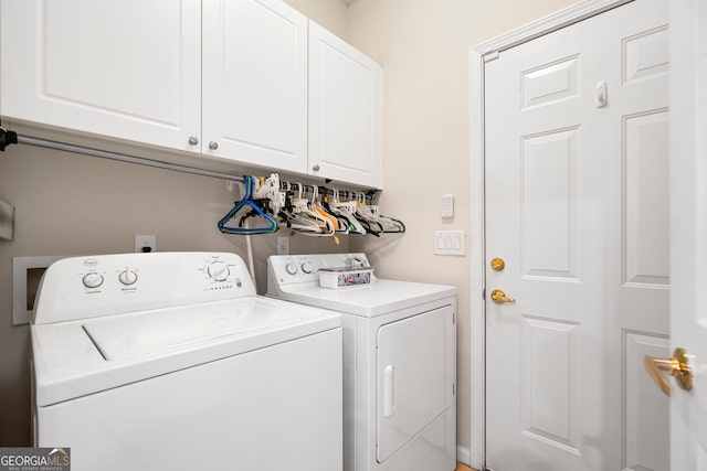 washroom with cabinet space and washing machine and dryer