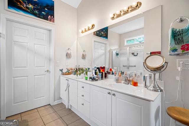 full bathroom with tile patterned flooring, a stall shower, and double vanity
