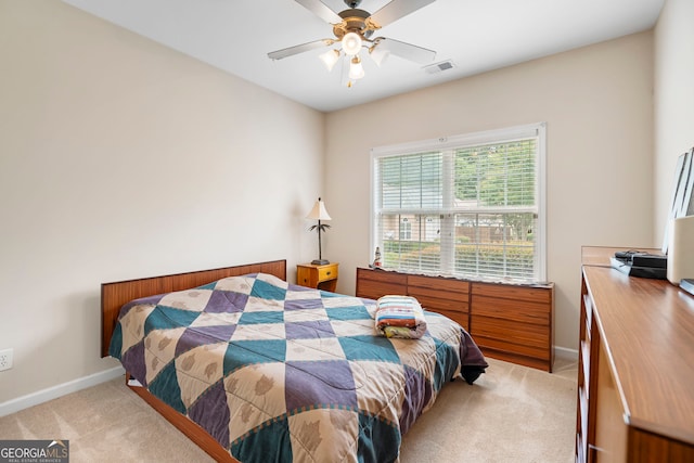 bedroom with light colored carpet, baseboards, and ceiling fan