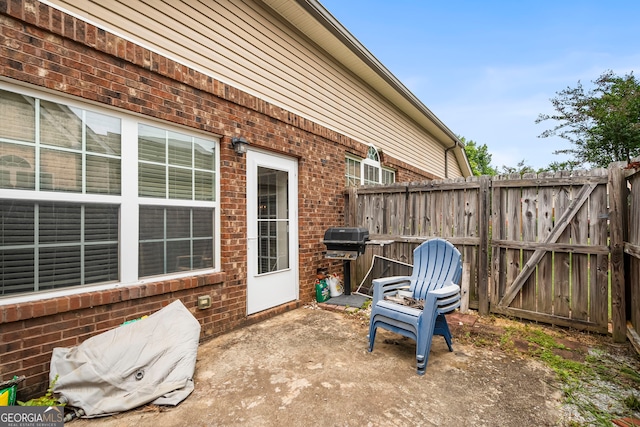 view of patio with fence and a gate