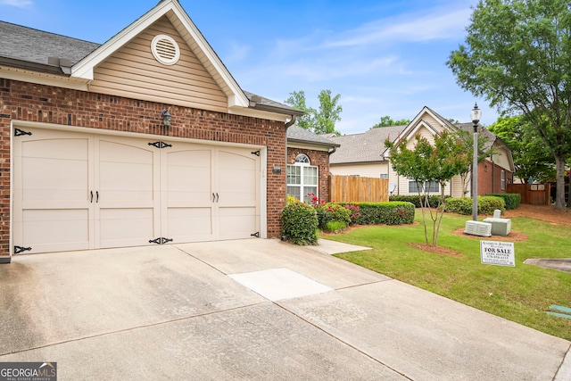 ranch-style home with concrete driveway, brick siding, an attached garage, and roof with shingles