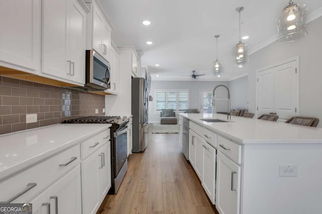 1768 Evenstad Way, Smyrna, GA 30080 - kitchen featuring stainless steel appliances, a sink, open floor plan, white cabinetry, and ceiling fan