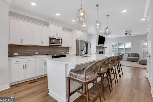 1768 Evenstad Way, Smyrna, GA 30080 - kitchen featuring stainless steel appliances, a sink, open floor plan, ceiling fan, and white cabinets