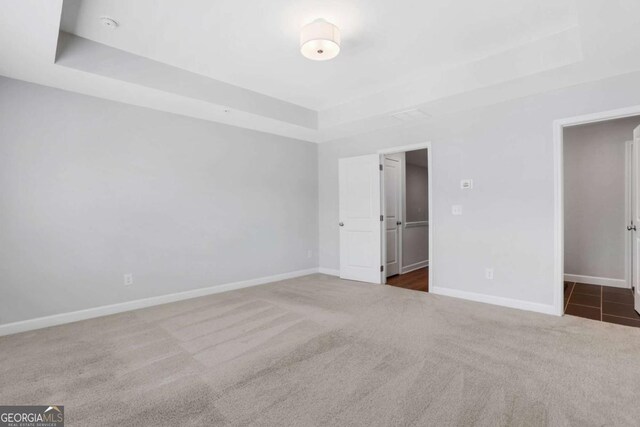 1768 Evenstad Way, Smyrna, GA 30080 - unfurnished bedroom with a tray ceiling, carpet floors, and baseboards