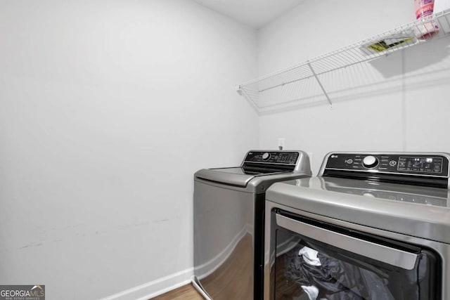 1768 Evenstad Way, Smyrna, GA 30080 - laundry area featuring washer and clothes dryer, wood finished floors, and baseboards