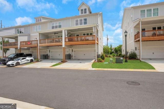 1768 Evenstad Way, Smyrna, GA 30080 - townhome / multi-family property featuring board and batten siding, an attached garage, driveway, cooling unit, and ceiling fan