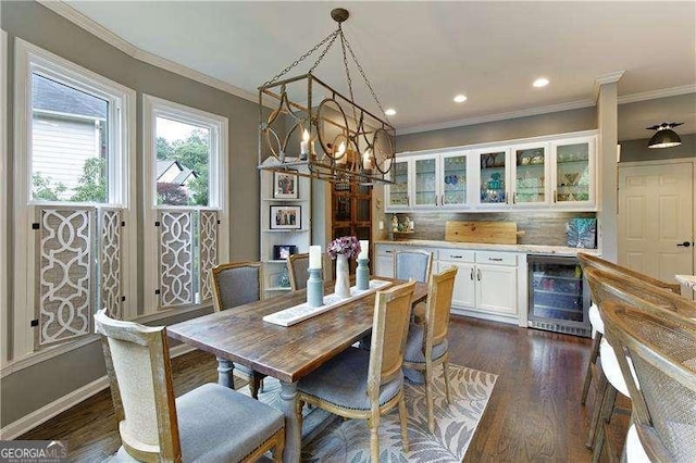 dining room with wine cooler, crown molding, dark wood-style floors, a dry bar, and recessed lighting