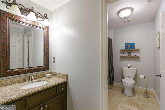 bathroom with crown molding, toilet, vanity, and baseboards