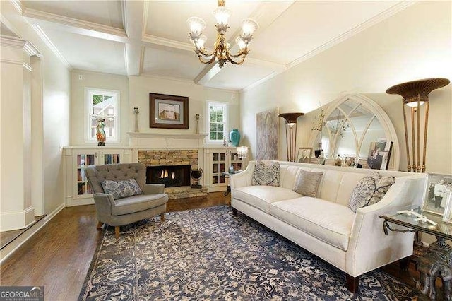 living room featuring coffered ceiling, wood finished floors, a chandelier, crown molding, and a fireplace