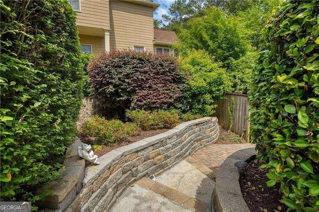view of yard with fence and a patio