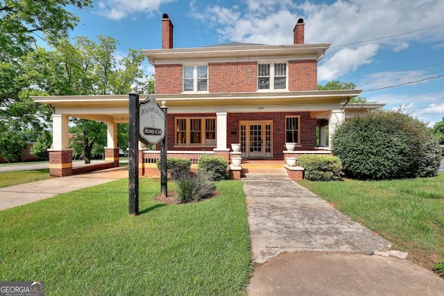 338 N Broad St, Monroe, GA 30655 - traditional style home featuring brick siding, a porch, a front lawn, and a chimney