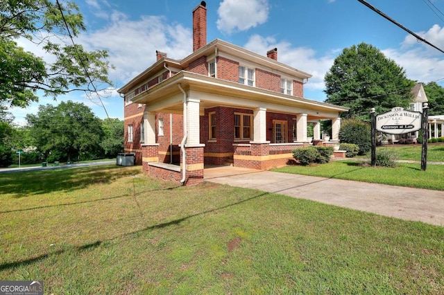 338 N Broad St, Monroe, GA 30655 - view of front of house with brick siding, a porch, a chimney, and a front lawn