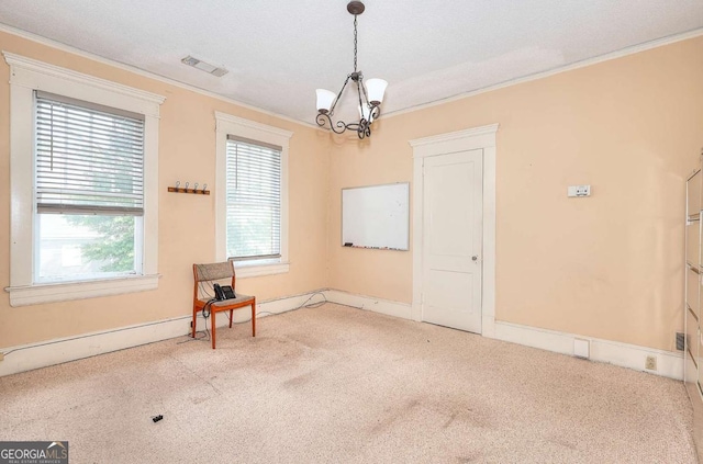 338 N Broad St, Monroe, GA 30655 - empty room featuring a chandelier, ornamental molding, carpet flooring, plenty of natural light, and baseboards