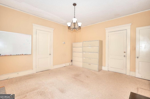 338 N Broad St, Monroe, GA 30655 - unfurnished dining area with a chandelier, carpet floors, and crown molding