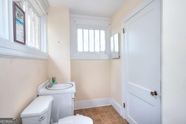 338 N Broad St, Monroe, GA 30655 - half bathroom featuring toilet, plenty of natural light, baseboards, and vanity