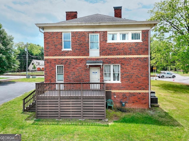 338 N Broad St, Monroe, GA 30655 - back of house featuring brick siding, a chimney, a yard, and a wooden deck