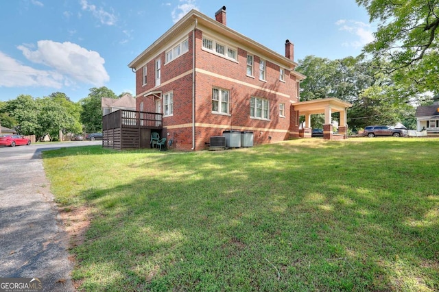 338 N Broad St, Monroe, GA 30655 - view of property exterior with a chimney, a lawn, brick siding, and central AC unit