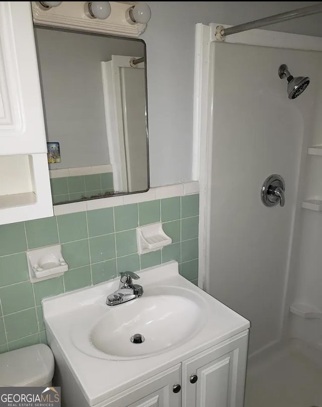2227 Robin Hood Rd, Macon, GA 31206 - bathroom featuring a shower stall, vanity, toilet, and tile walls