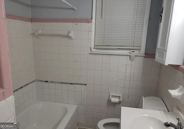 2227 Robin Hood Rd, Macon, GA 31206 - full bath with tile walls, toilet, and a sink