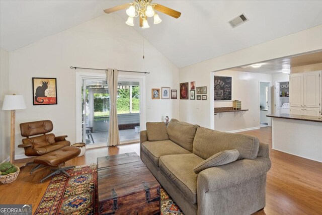 2507 Wateringhole Ct, Statesboro, GA 30458 - living area with ceiling fan, wood finished floors, high vaulted ceiling, and washer / clothes dryer