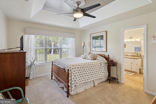 2507 Wateringhole Ct, Statesboro, GA 30458 - bedroom with light carpet, baseboards, connected bathroom, ceiling fan, and a tray ceiling